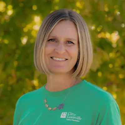 Ms Emily, preschool teacher, smiling outdoors.