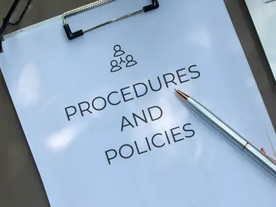 Documents labeled “Procedures and Policies” on a desk.