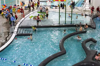 Indoor swimming pool with and swimmers.