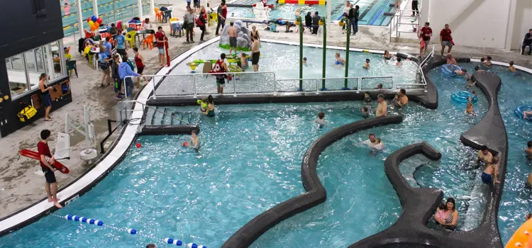 Indoor swimming pool with and swimmers.