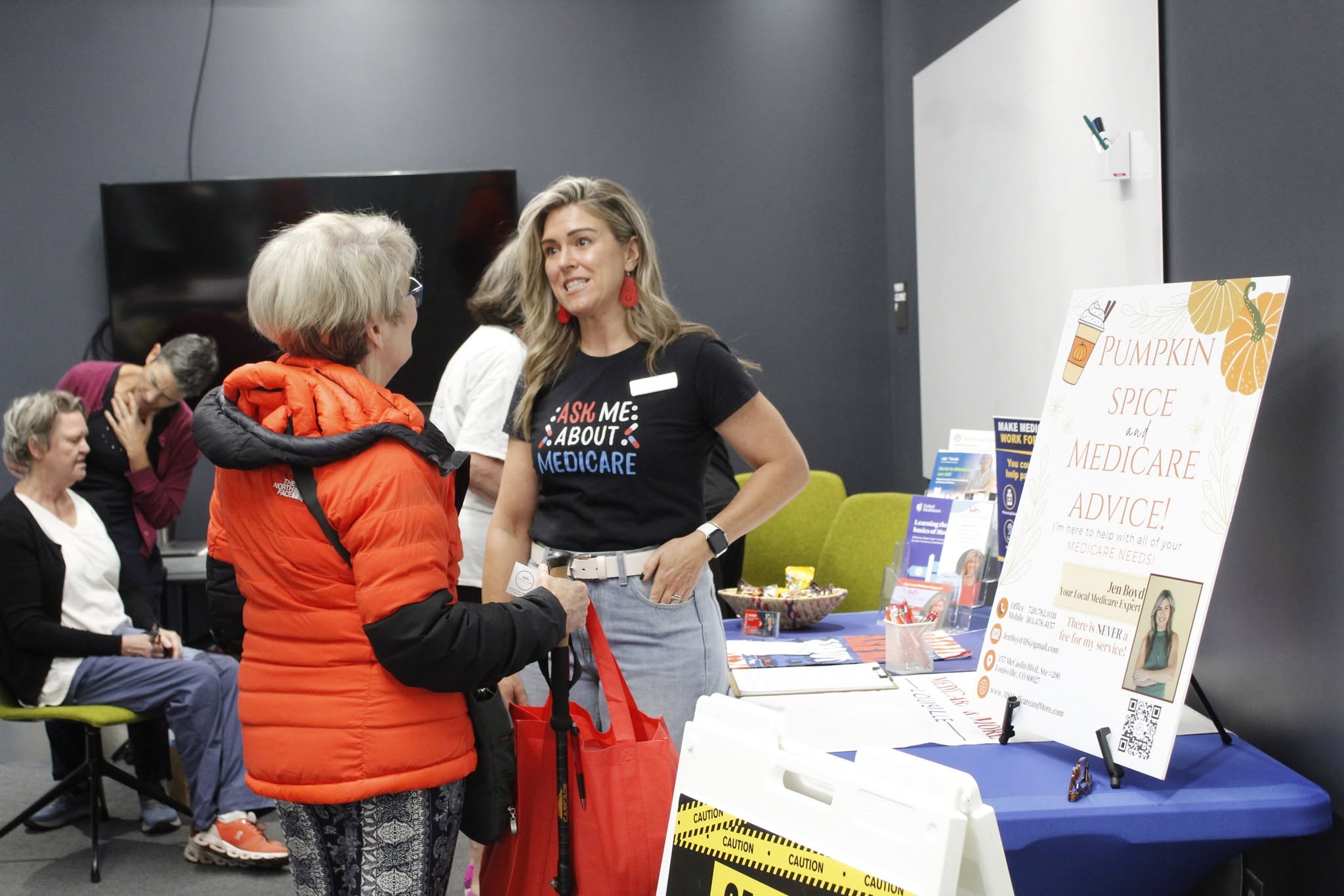 A senior talking to a lady about medicare during a senior resource fair