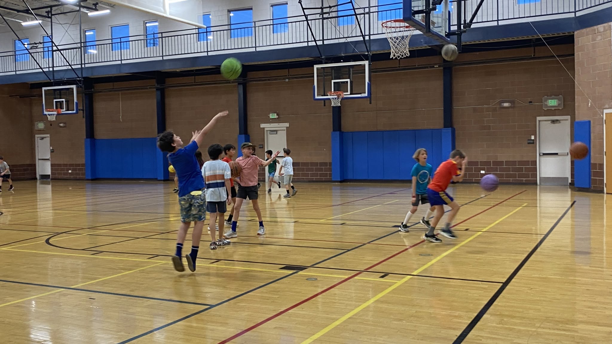 Youth basketball game in an indoor gymnasium.