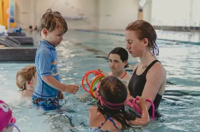 Supervising adult with children in a pool.